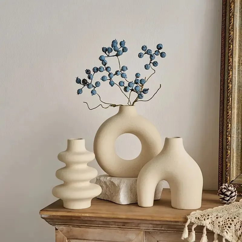 Bohemian ceramic vase trio styled on a wooden console