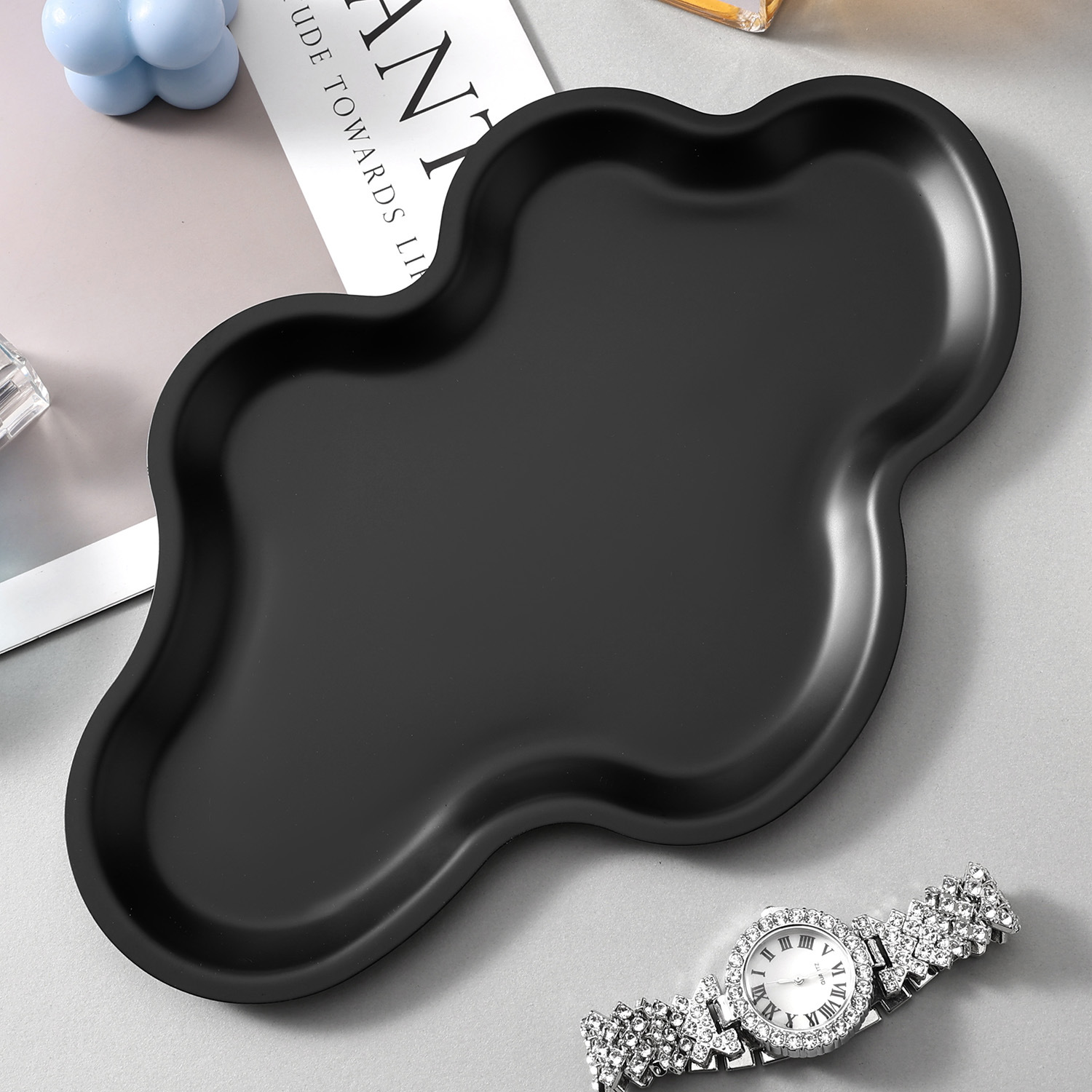 Black cloud-shaped tray styled with a watch