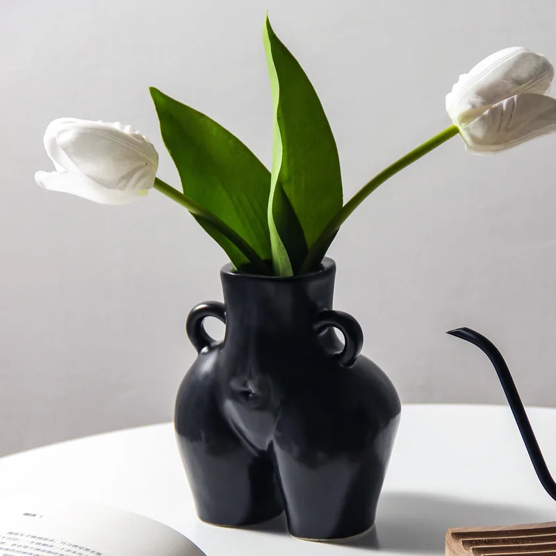 Frosted black ceramic torso vase with white tulips