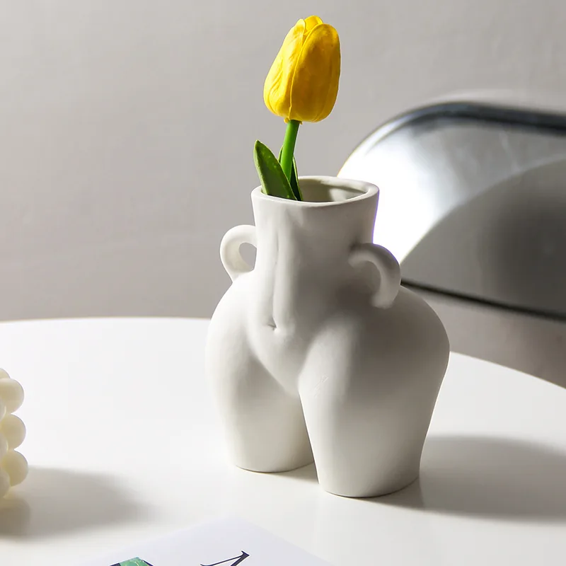 White sculptural ceramic body vase with yellow tulip