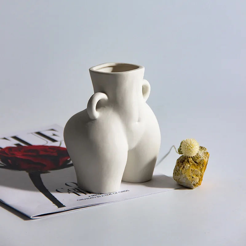 Frosted white ceramic torso vase in a modern display