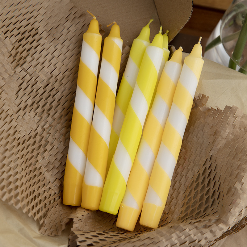 Yellow and white striped Christmas taper candles