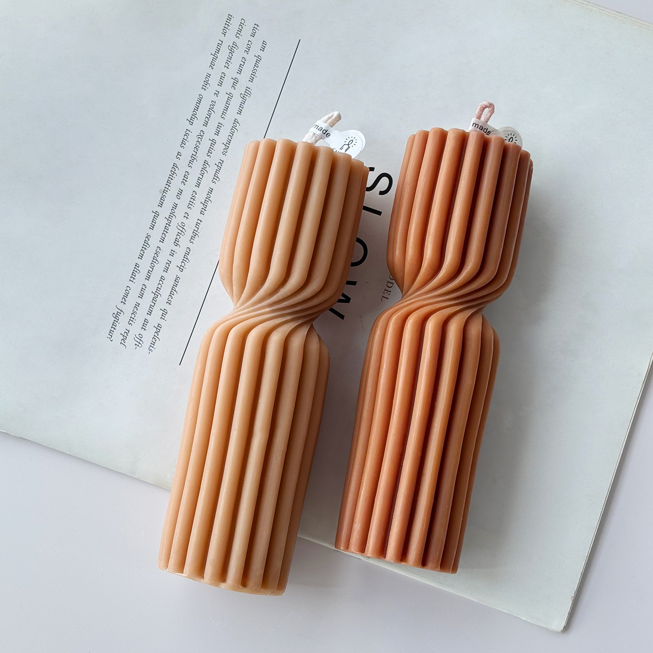 Two tall ribbed hourglass scented pillar candles
