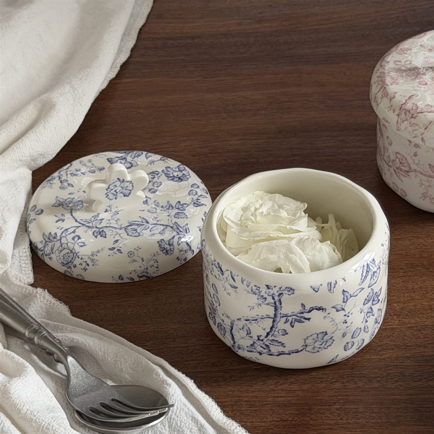 Open blue floral ceramic lidded bowl used for decorative storage
