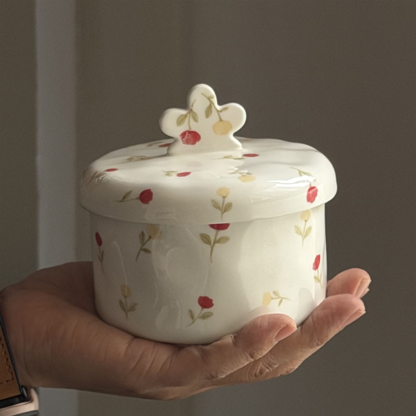 Petite floral ceramic candy bowl held in one hand