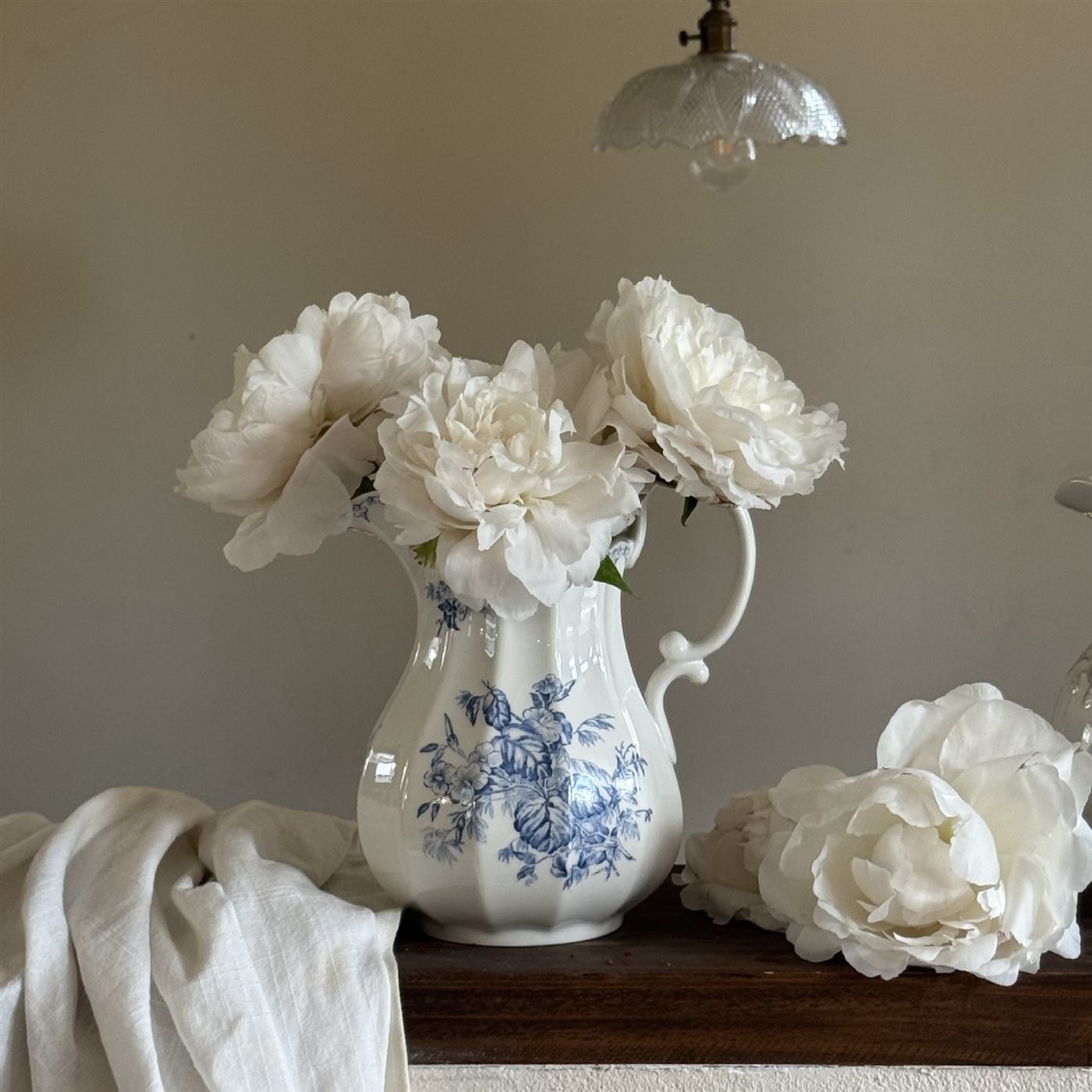 Blue and white ceramic vase displaying a floral arrangement