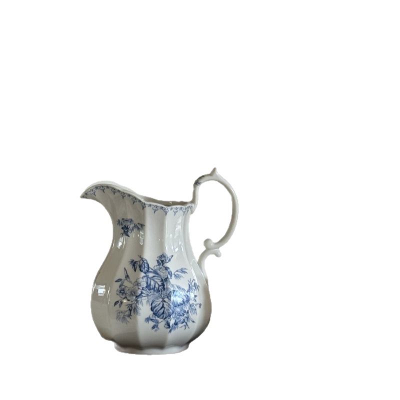 French floral ceramic pitcher vase on a white background