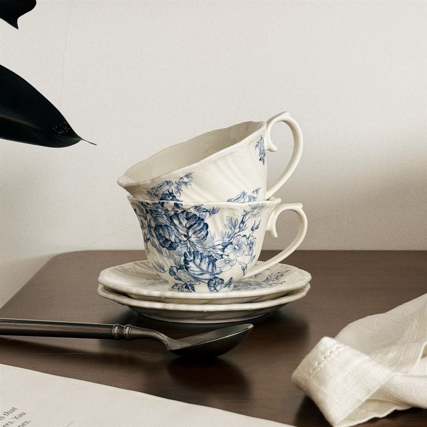 Stacked French vintage floral ceramic cups and saucers