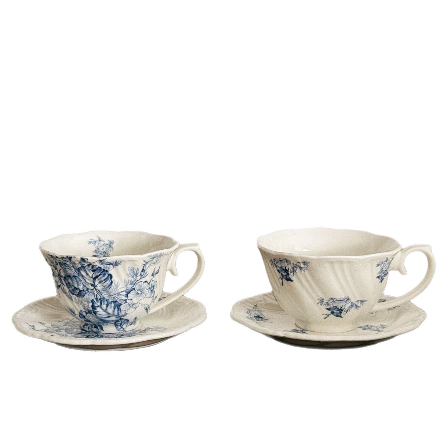 Two blue floral ceramic cup and saucer sets on white