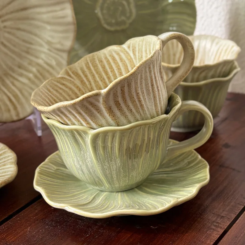 Stacked white and green reactive glaze ceramic cups