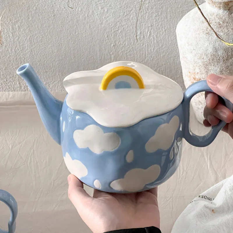 Cloud teapot held by hand