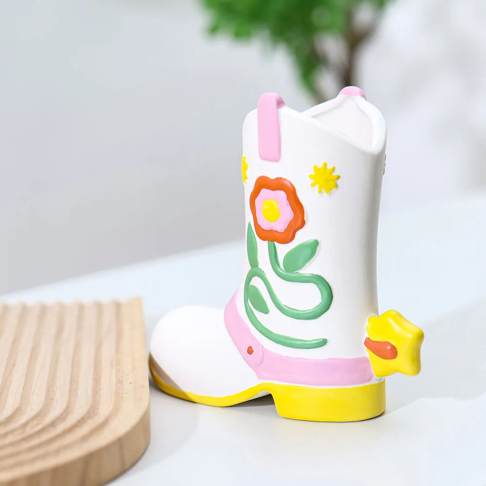 Side view of colorful ceramic boot vase