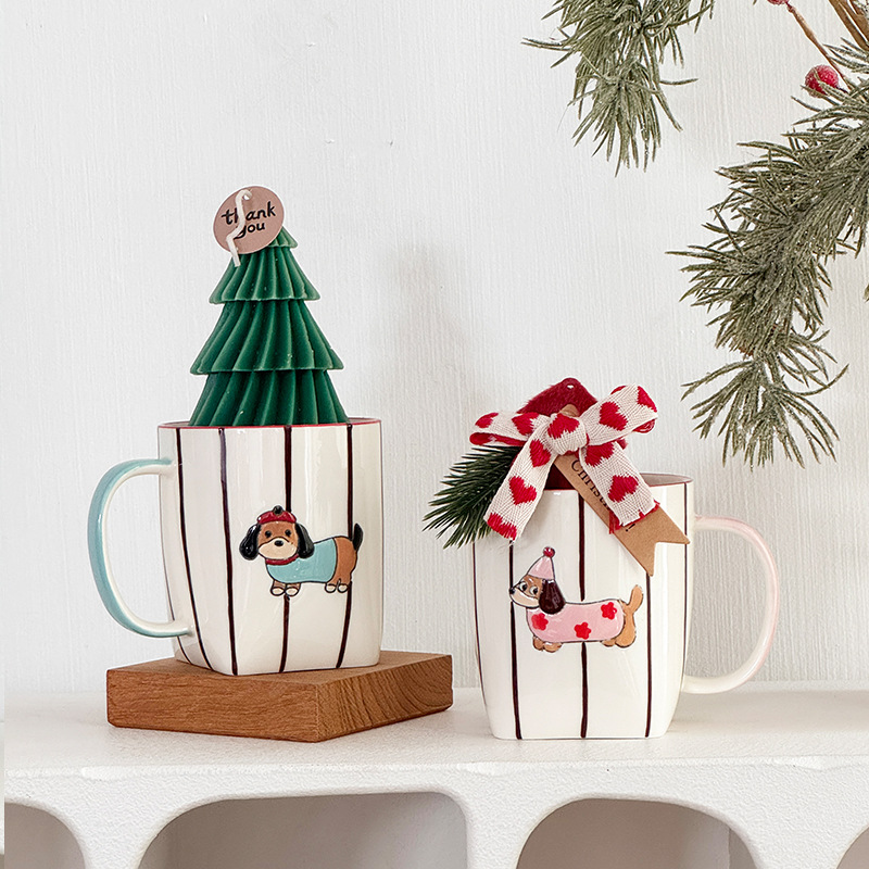 Blue and pink dachshund mugs in a festive display
