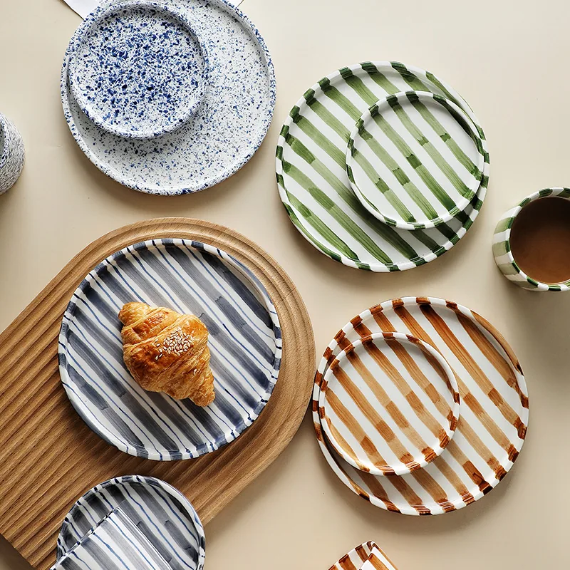 Matching striped ceramic saucers and plates