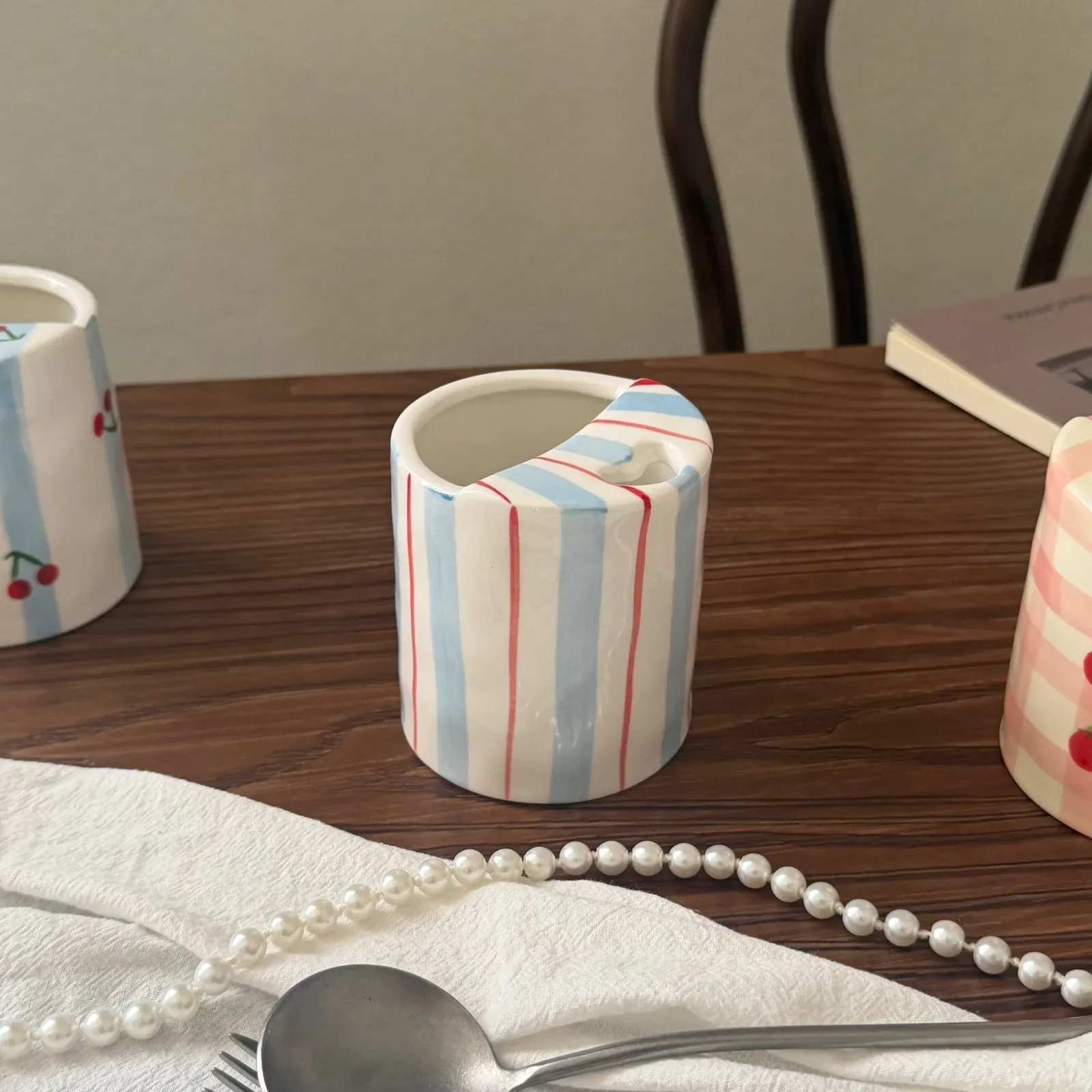 Blue and red striped mug with integrated spoon rest