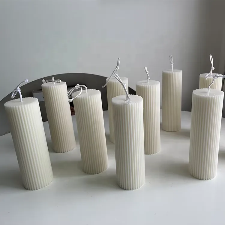 Collection of tall white handmade pillar candles