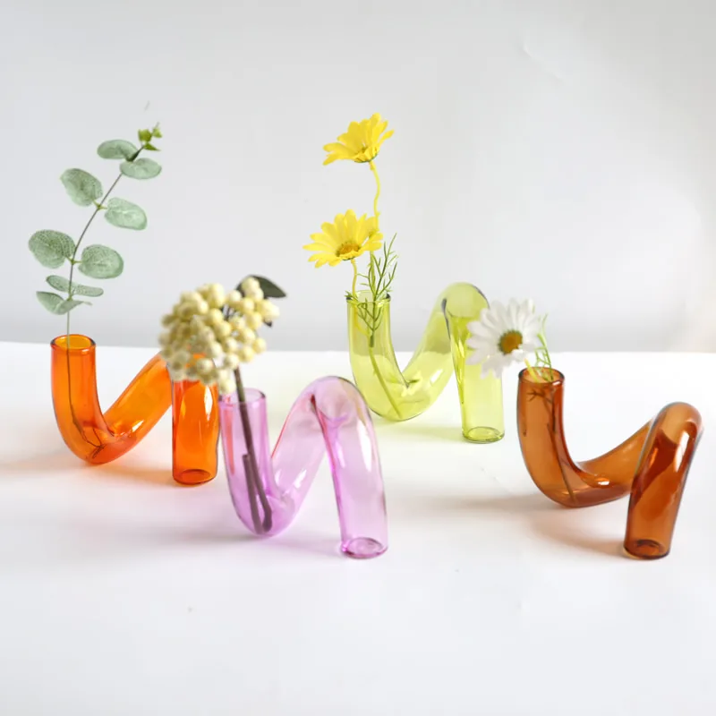 Colorful irregular glass vases with flowers
