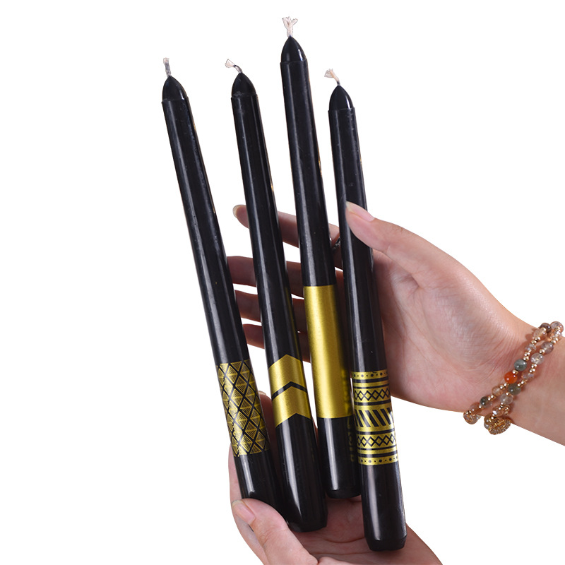 Four black and gold taper candle designs