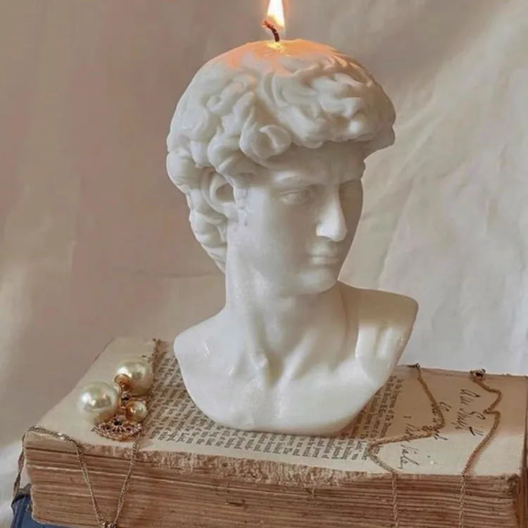 Burning white David bust candle