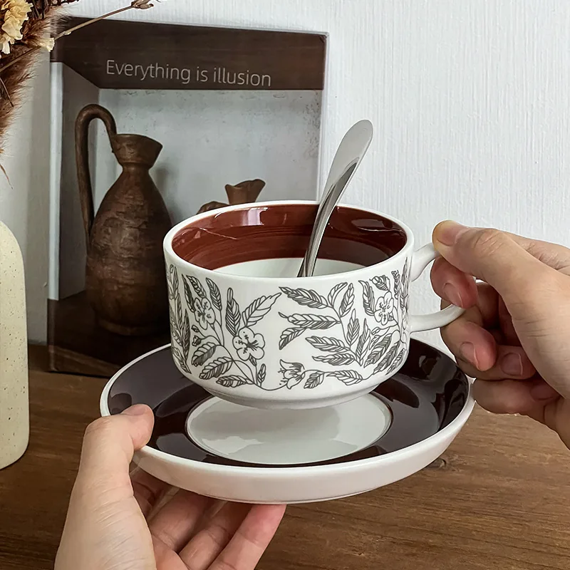 Brown floral ceramic coffee cup and saucer