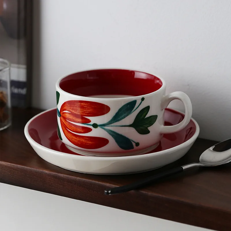 Red floral ceramic coffee cup and saucer