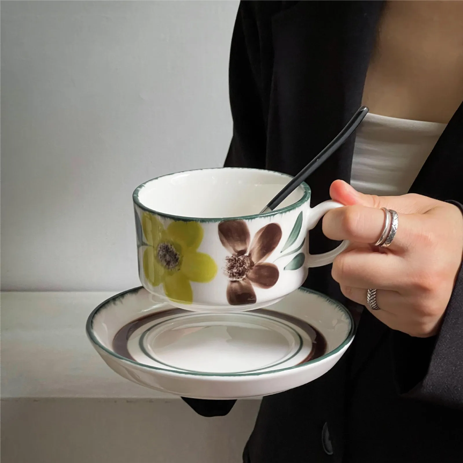 White floral ceramic coffee cup and saucer