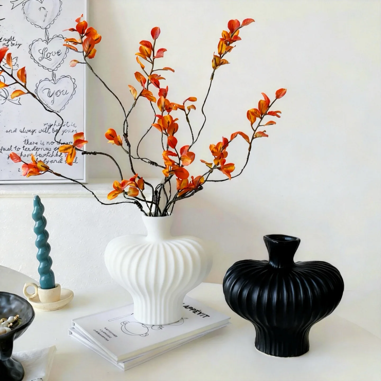 White and black mid-century vases with orange branches
