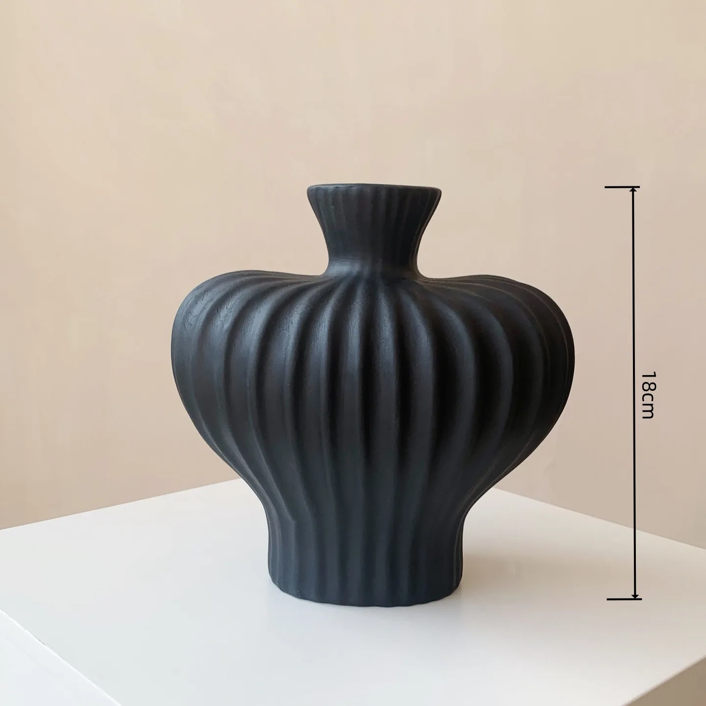 Small black ribbed ceramic vase with 18 cm height