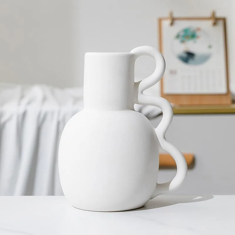 Front view of minimalist white ceramic vase with triple-loop handle