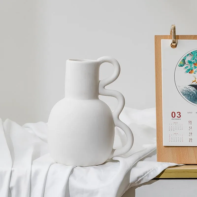 White ceramic decorative vase styled on soft fabric