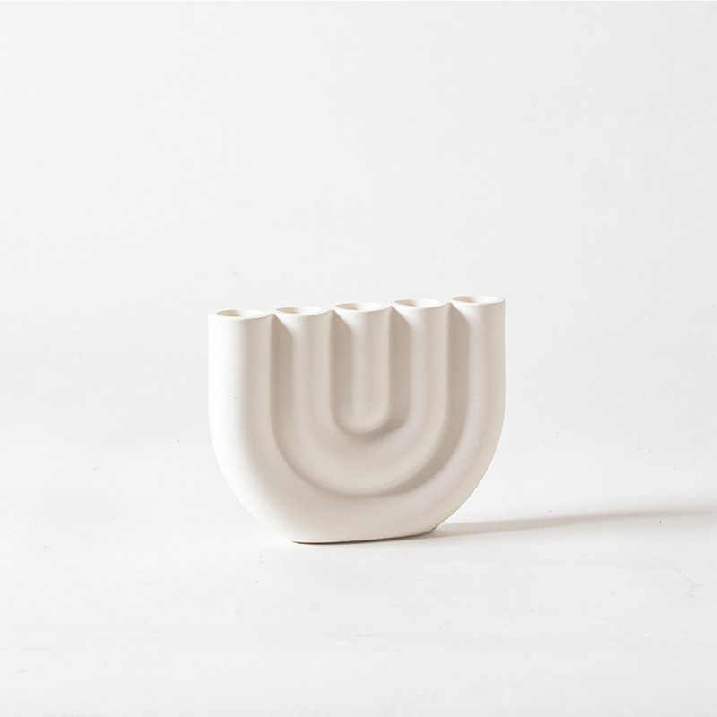 White porcelain multi arm candle holder with nested curves