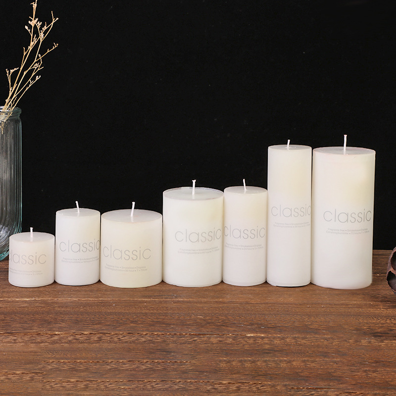 Seven white pillar candles arranged by height