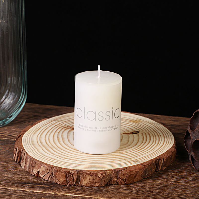 Medium white pillar candle on rustic display