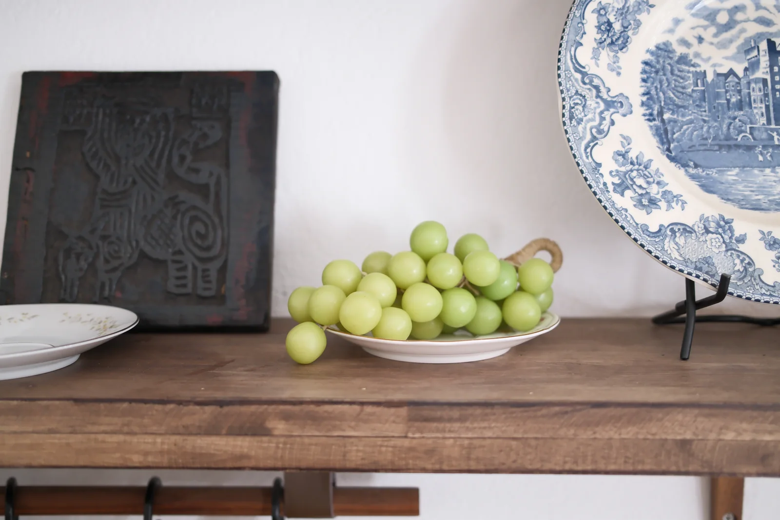 Green grape cluster candle on a display plate