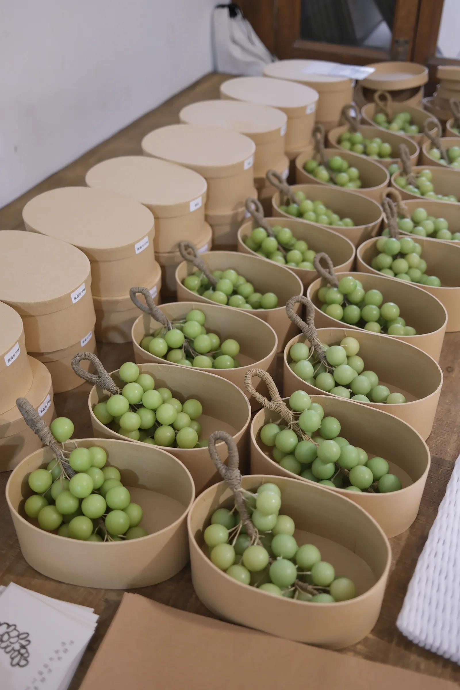 Green grape candles arranged in gift boxes
