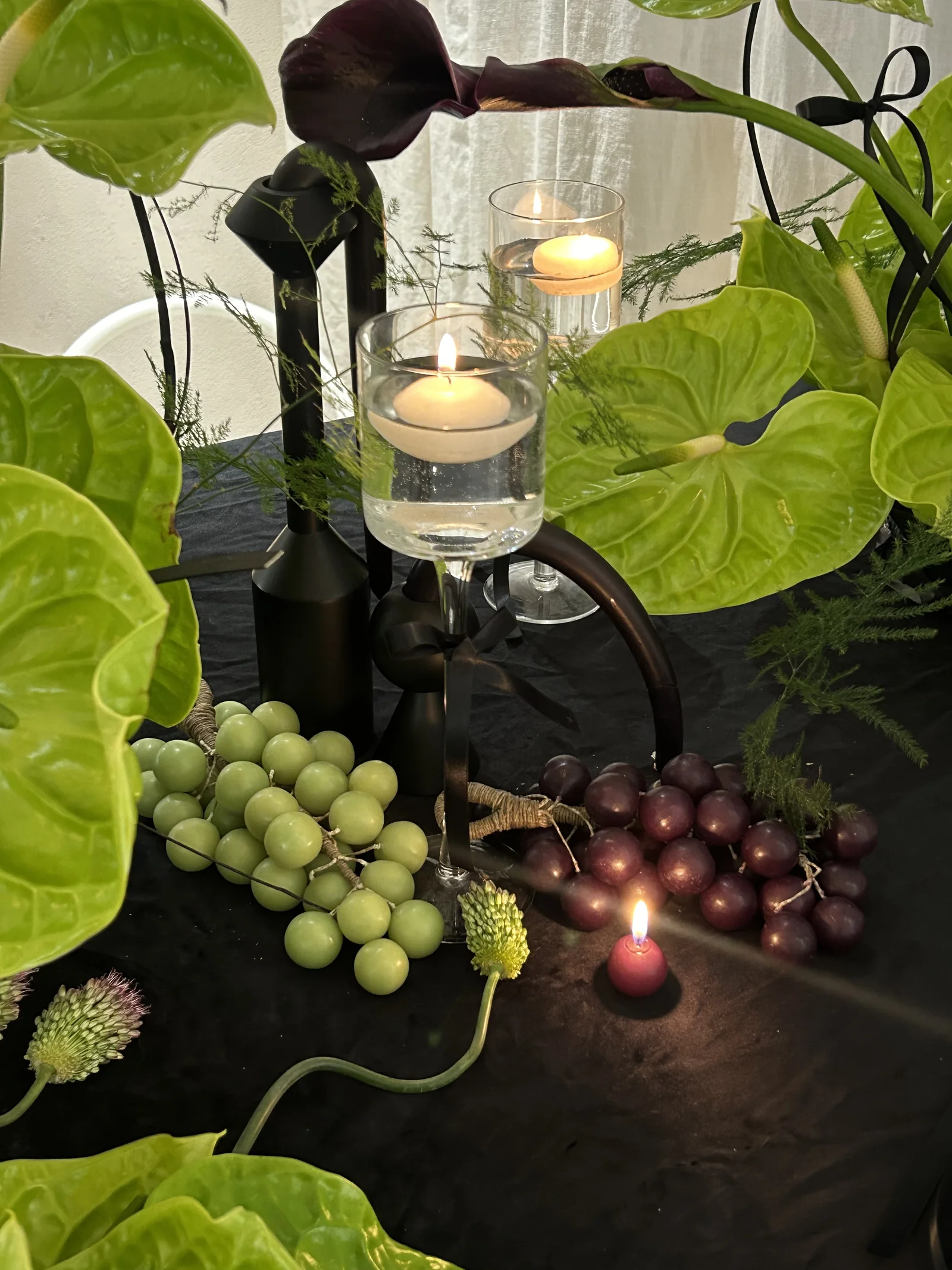 Grape candles in an evening floral display