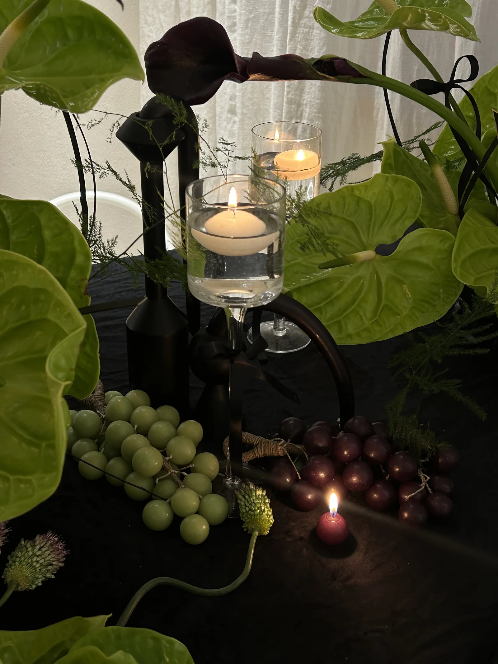 Purple and green grape candles with floating candles