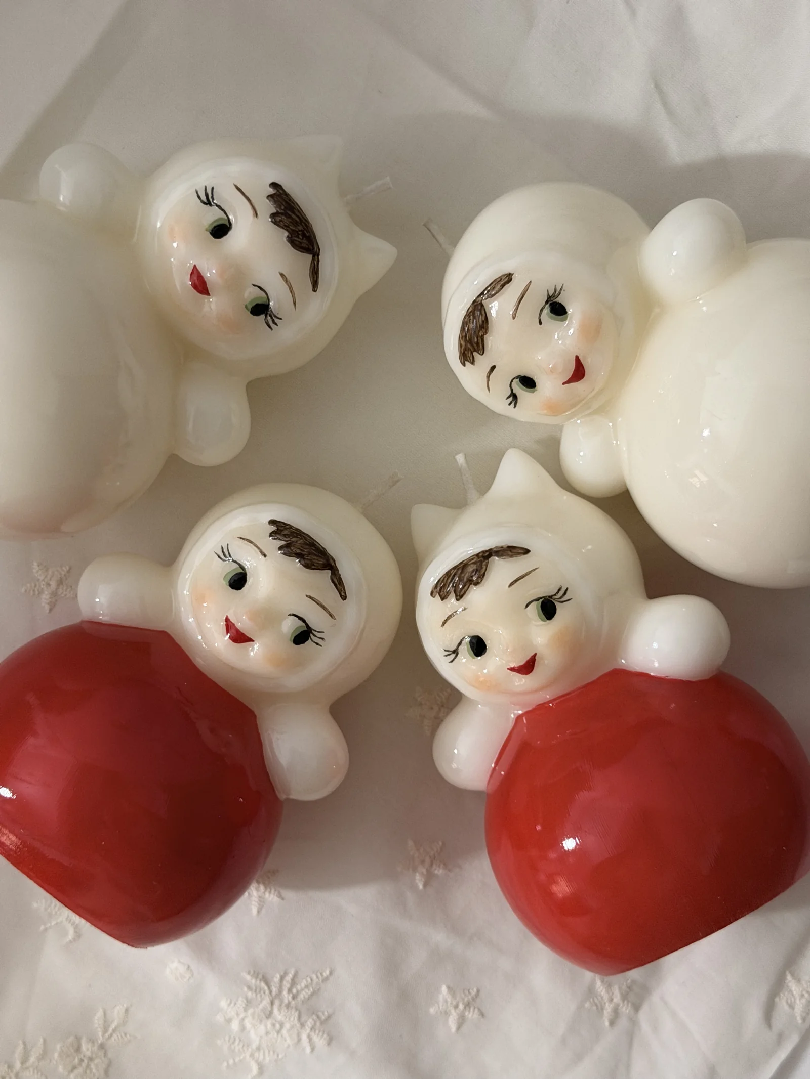 Close-up of red and ivory doll candles