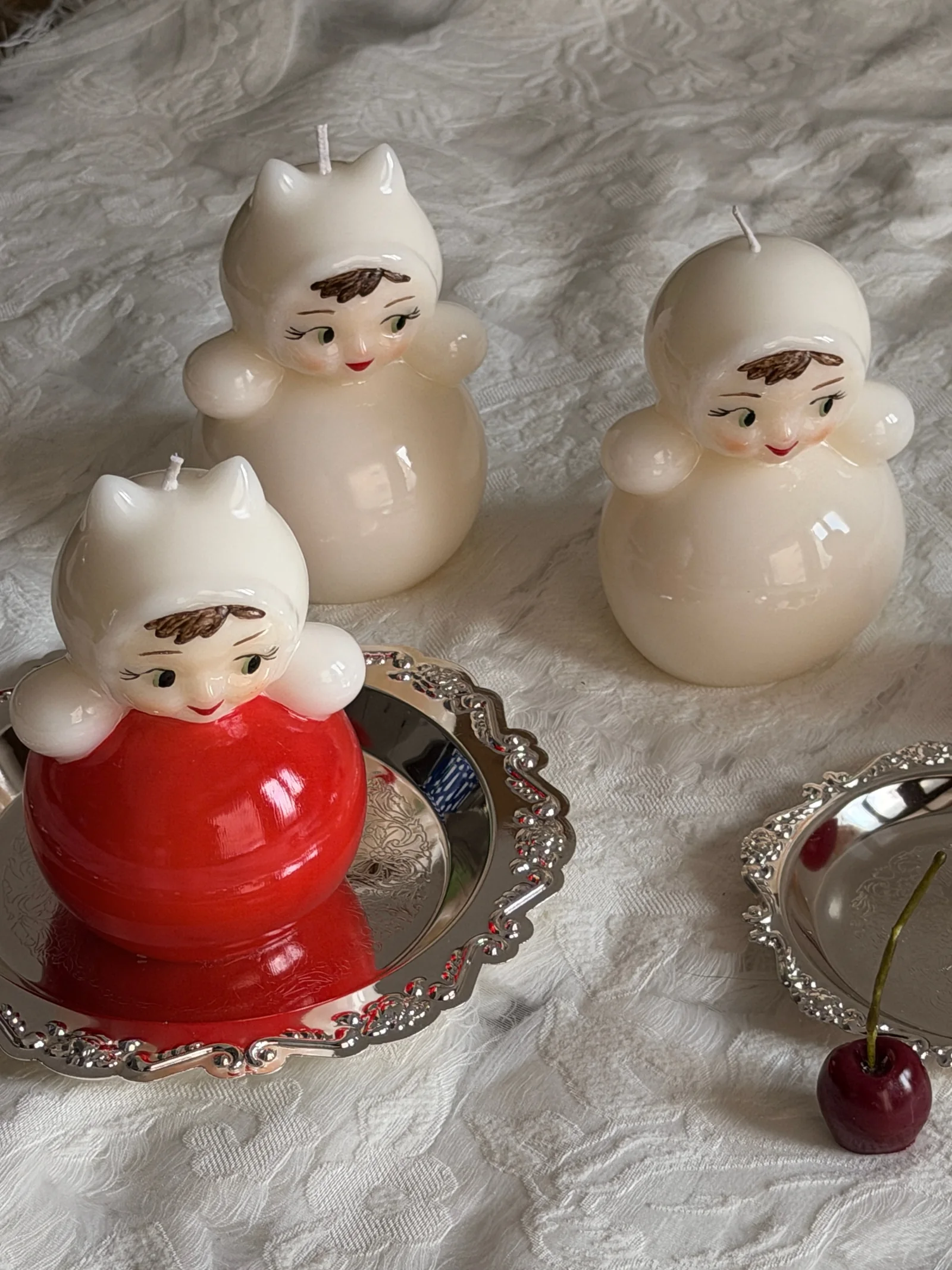 Vintage doll candles styled with a silver tray