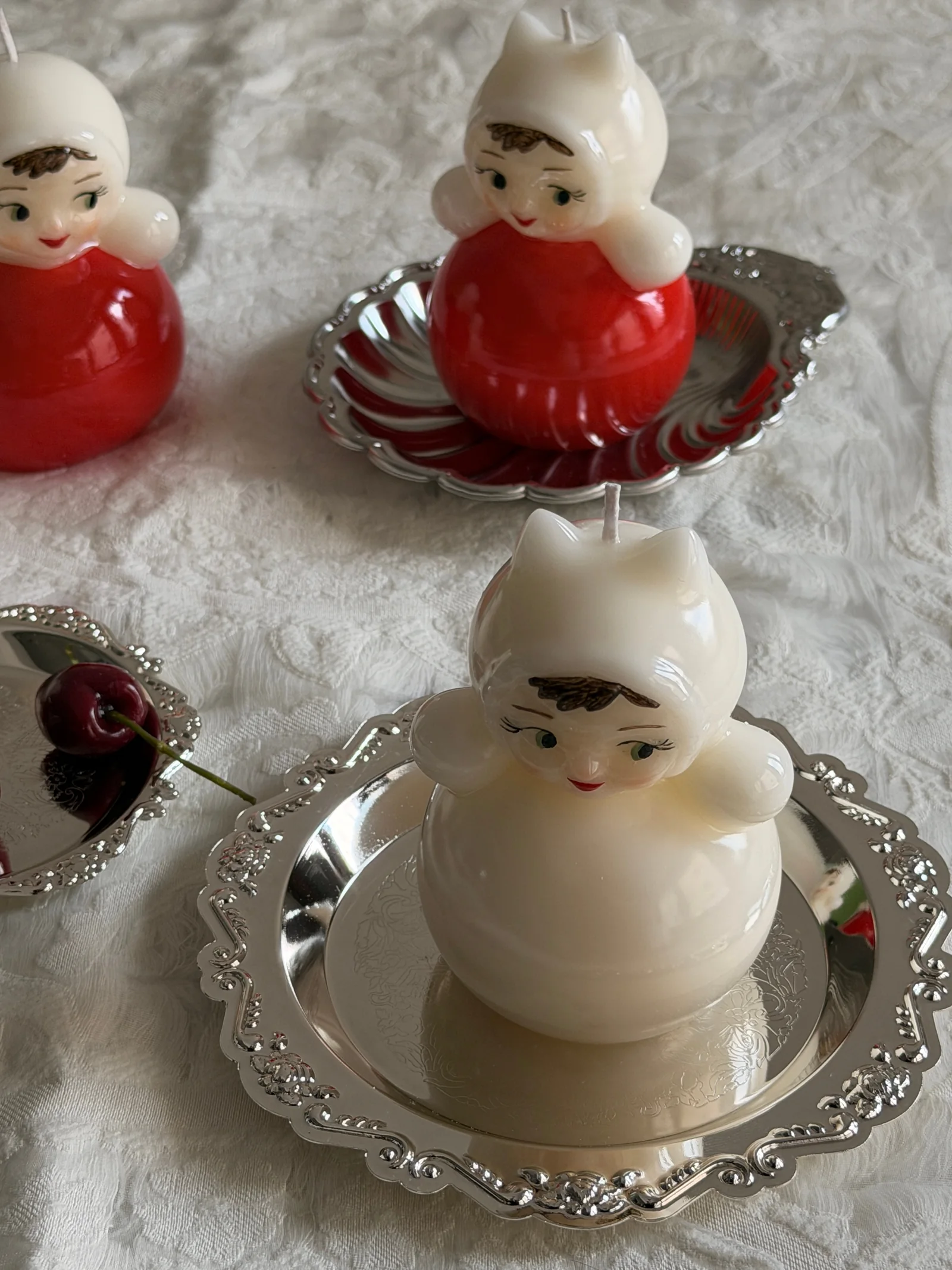 Ivory doll candle displayed on a vintage silver tray