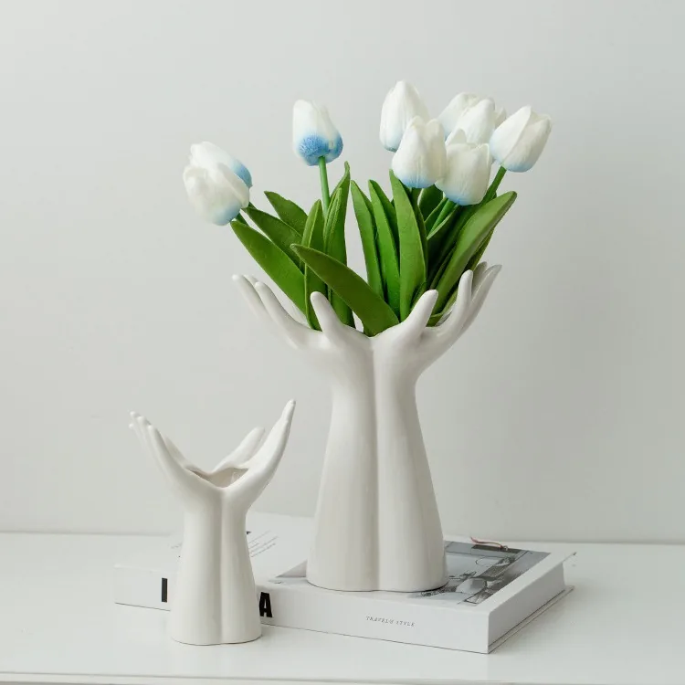 Small and large hand vases on books