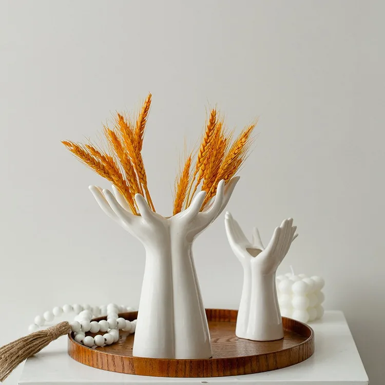 White hand vases with dried wheat