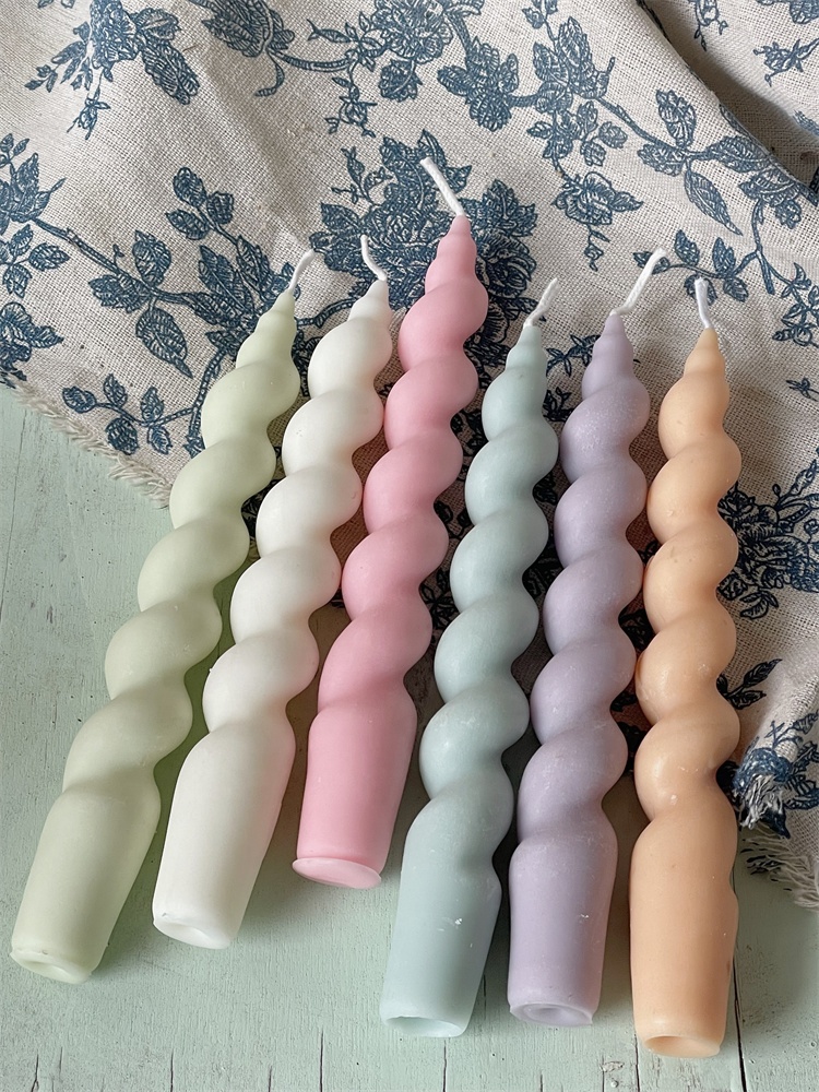 Custom color spiral candles styled on floral fabric
