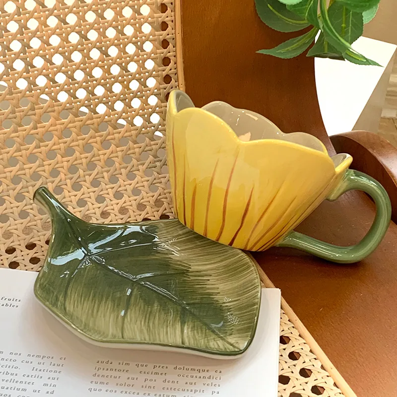 Yellow tulip ceramic cup with leaf-shaped saucer