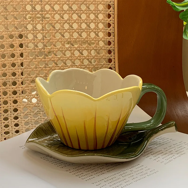 Yellow tulip flower cup and green leaf saucer
