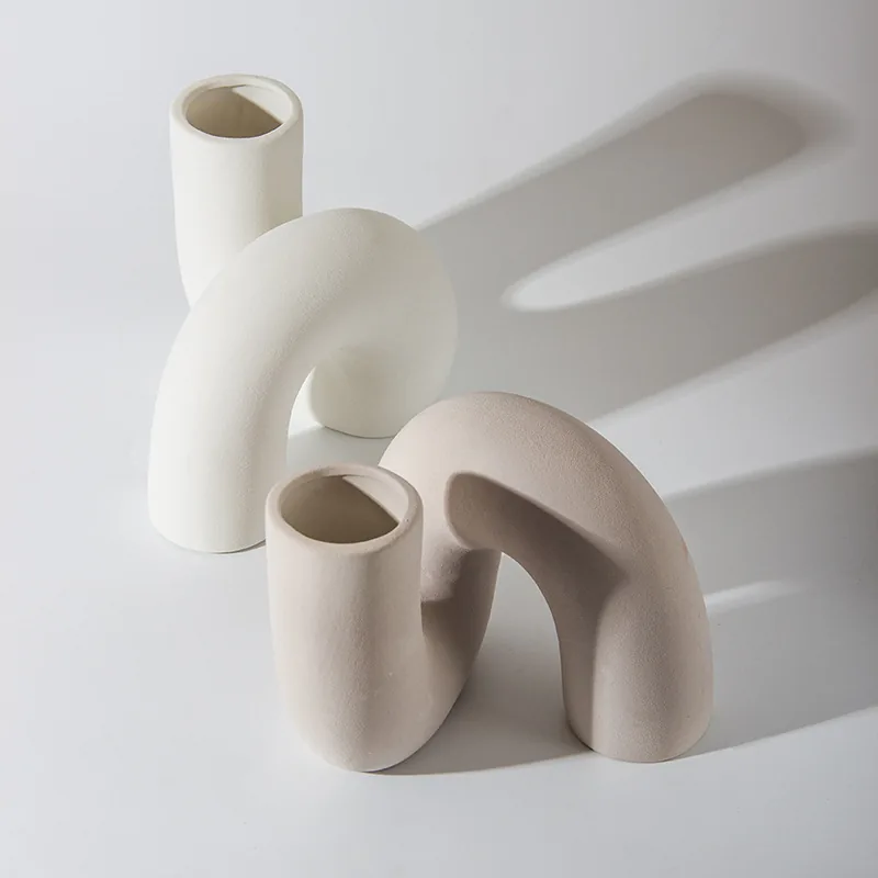 Modern arch-shaped ceramic vases in two neutral colors