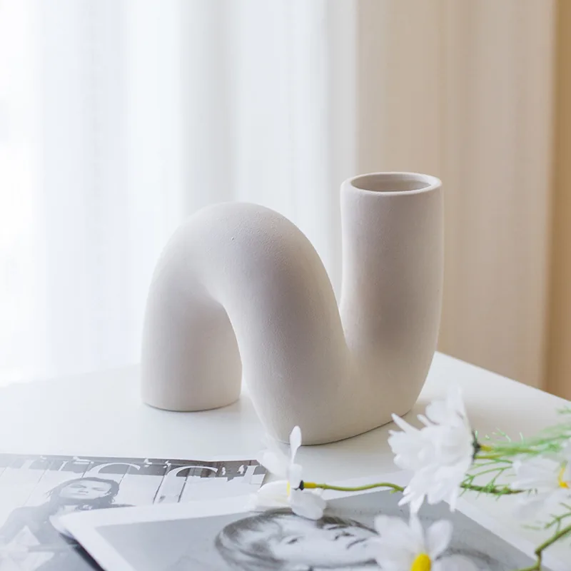 White twist ceramic vase in a minimalist interior
