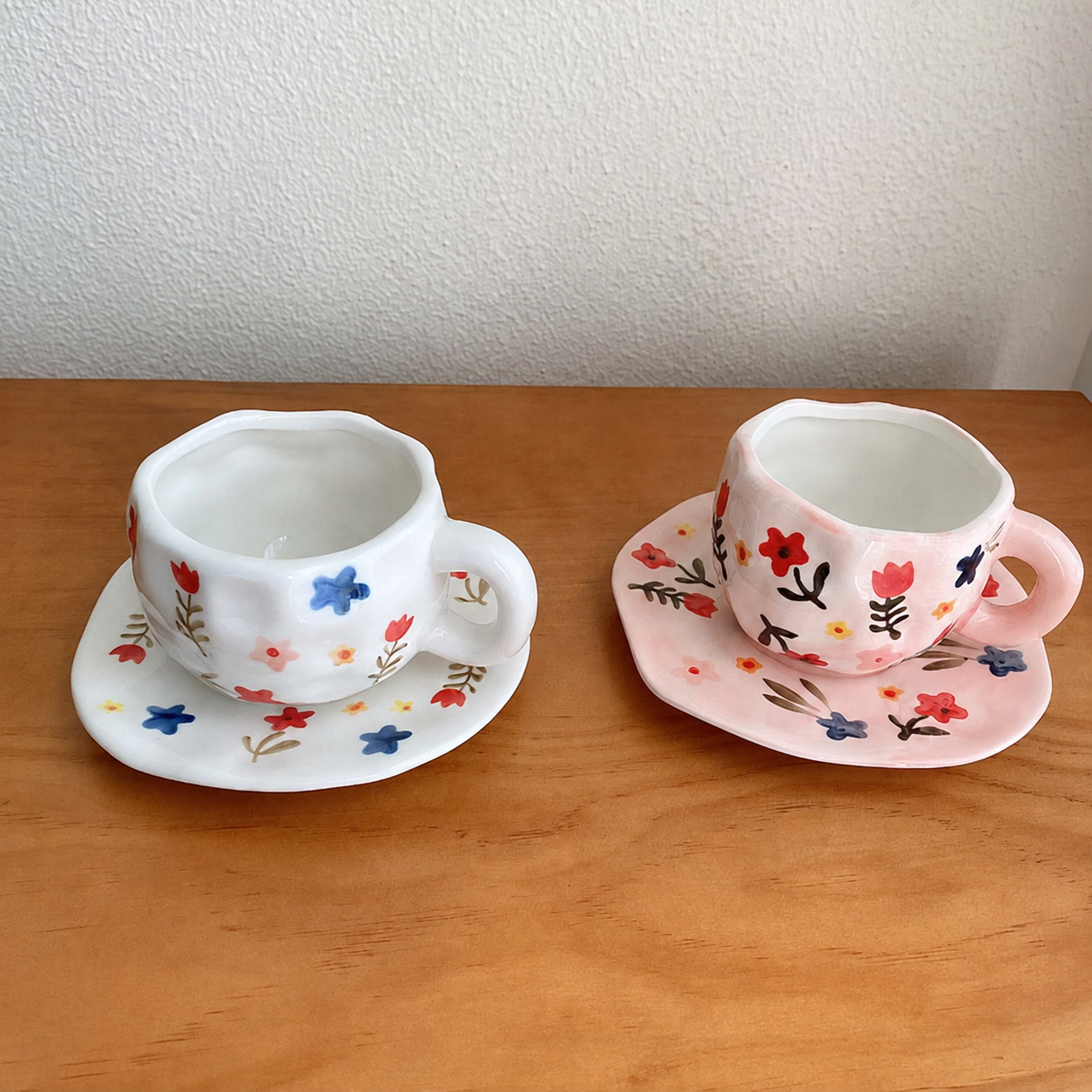 White and pink floral ceramic cup and saucer sets