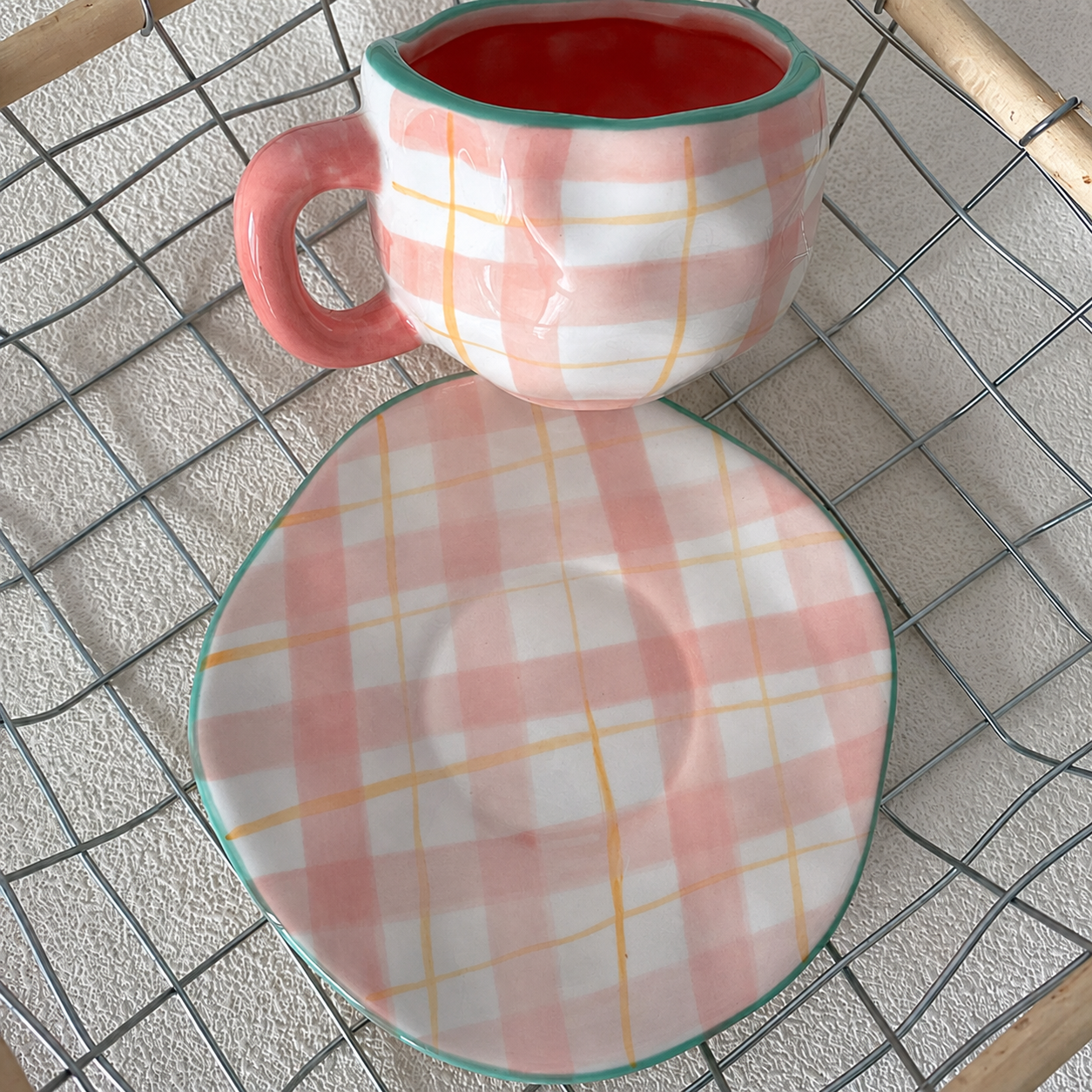 Pink plaid ceramic cup and irregular saucer