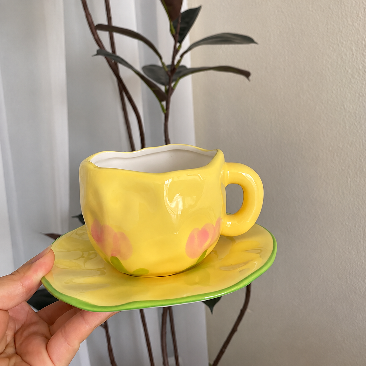 Yellow floral ceramic cup and saucer set